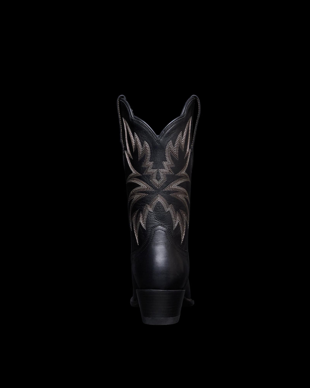 View of the back of the sadie boot in the color midnight. 