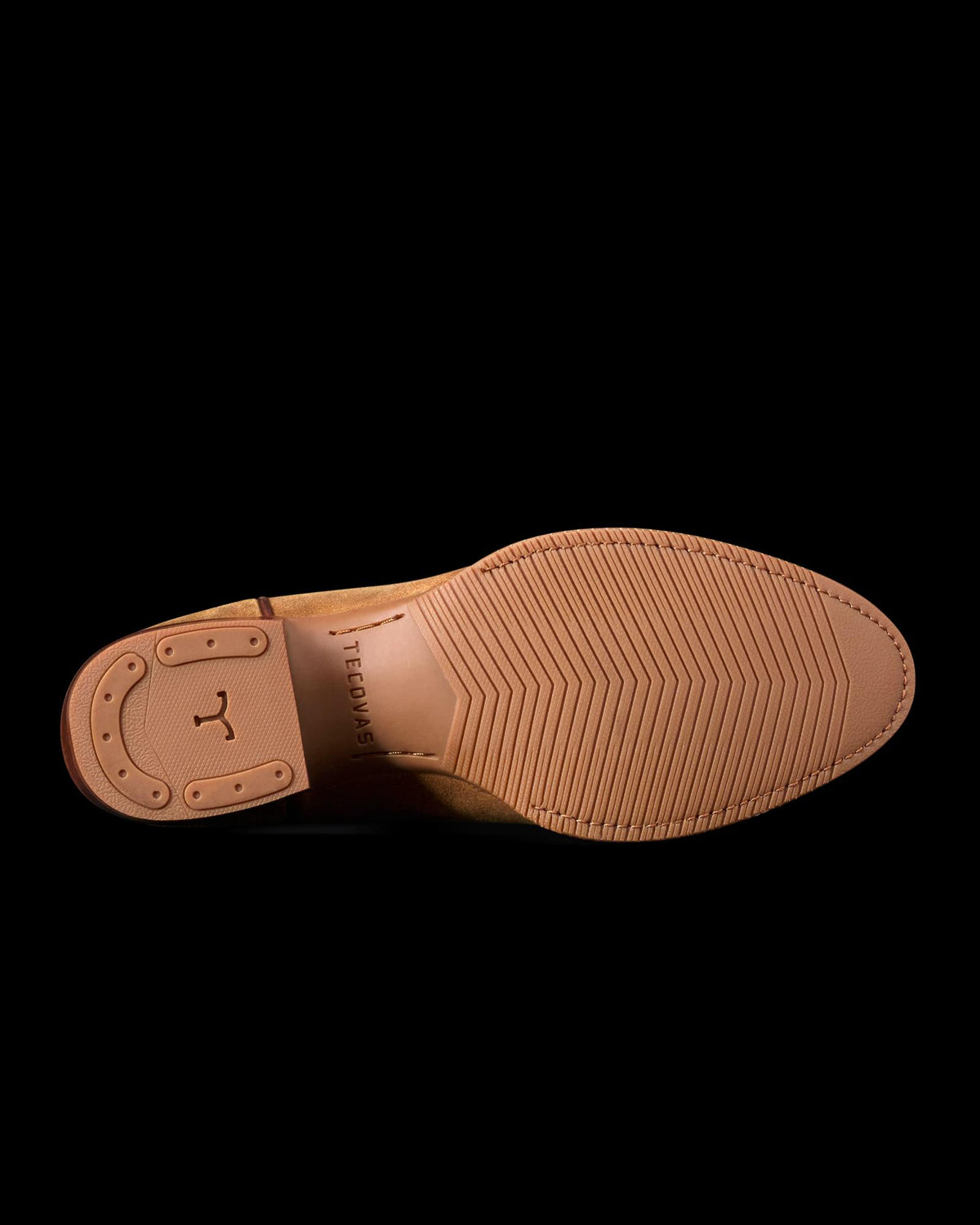 The Buck in Copper Cowhide. The image shows the sole of a brown dress shoe crafted from The Buck Cowhide, featuring textured rubber tread and a stitched heel cap.