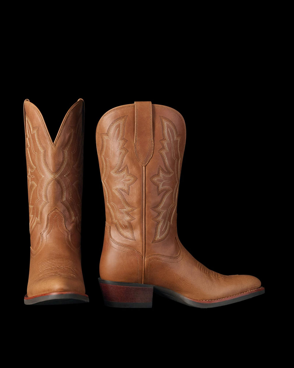 The Britt in Latte Goat. A pair of brown leather cowboy boots from Latte Goat, featuring decorative stitching and angled heels, shown from the side and back.