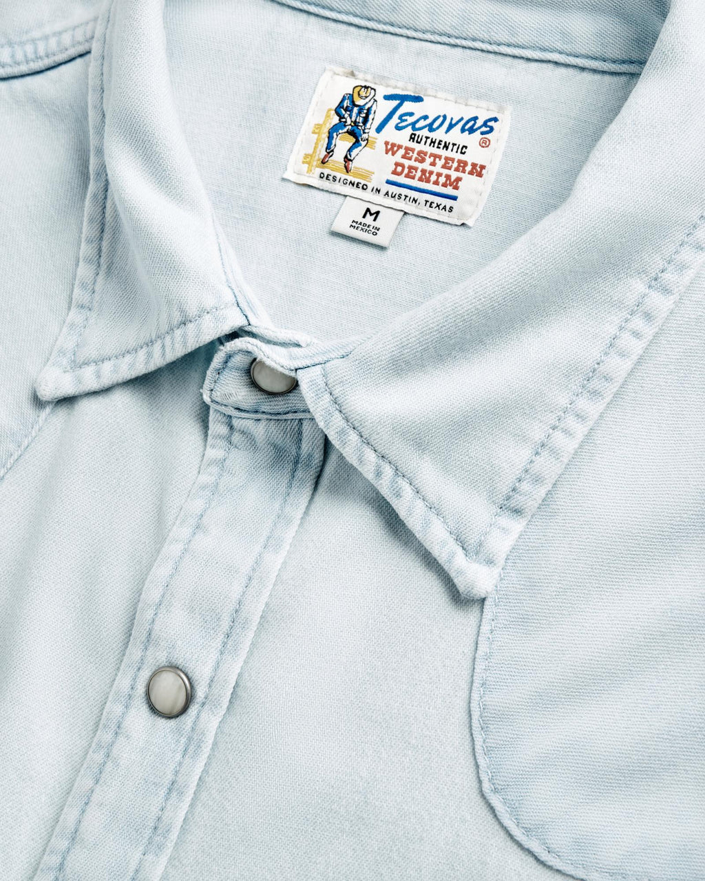 Closeup detail view of Men's Denim Long Sleeve Pearl Snap - Ultra Light