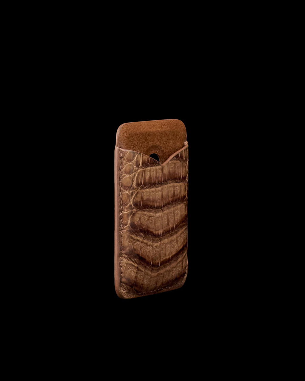 A brown crocodile-patterned leather phone sleeve stands upright against a plain white background.