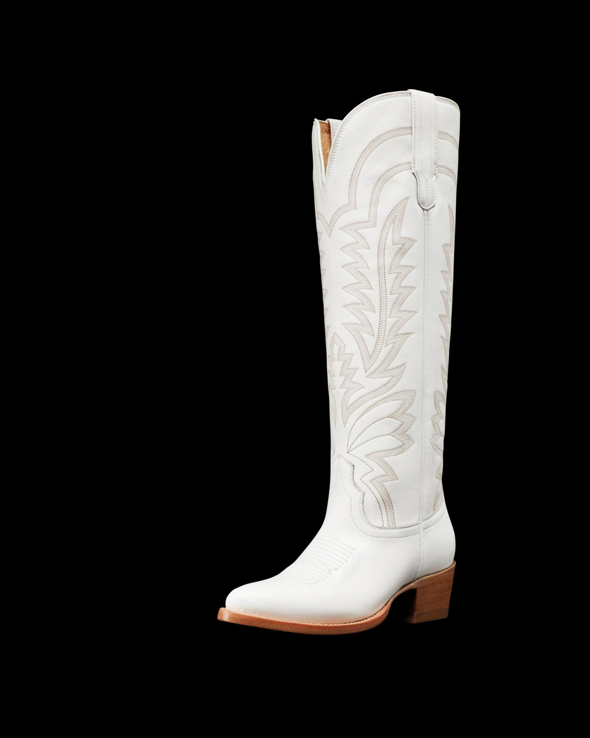 A tall, white cowboy boot with decorative stitching and a brown heel, viewed from the side.