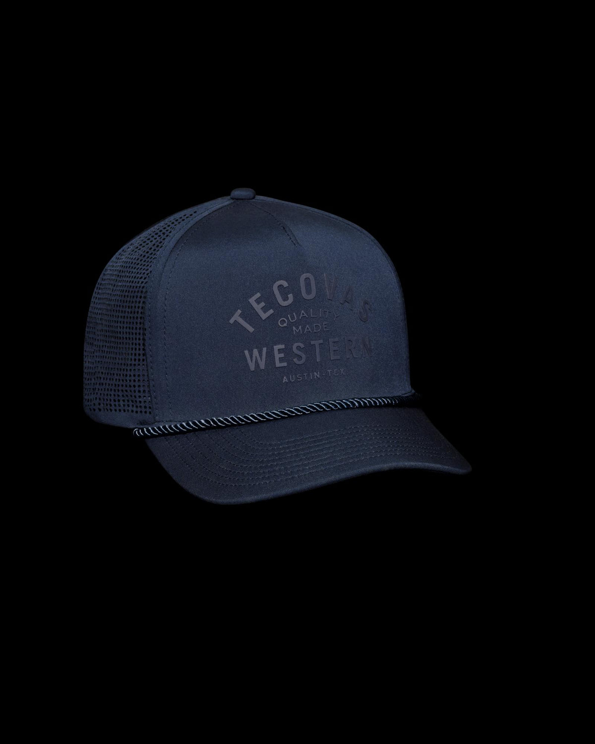 Navy blue mesh trucker hat with "Tecovas Western" text on the front and a black braided rope across the brim, set against a plain white background.