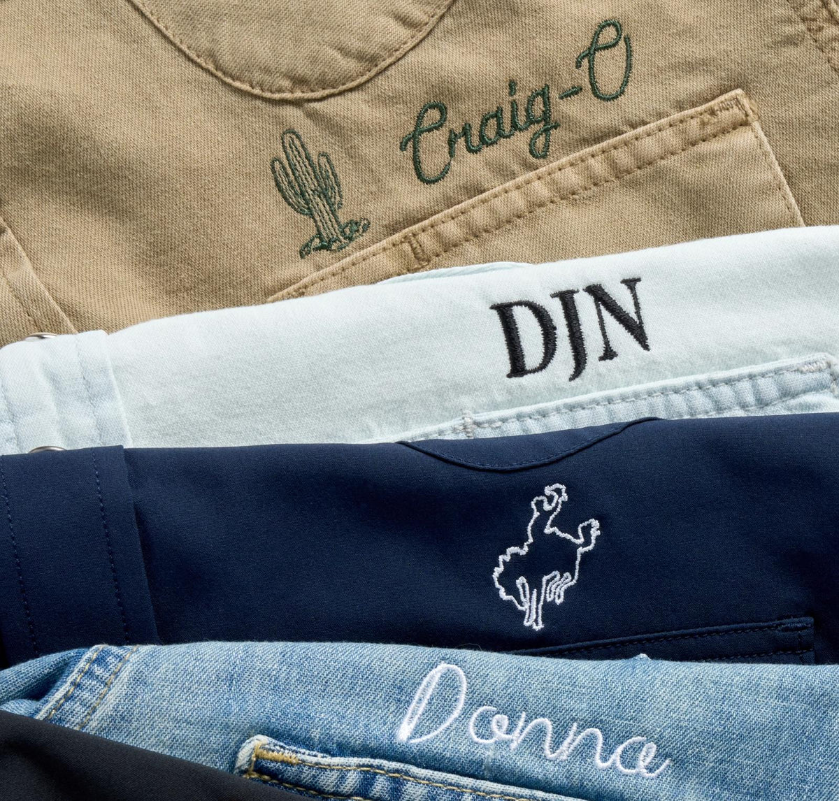 Embroider stack of shirts with different icons and symbols