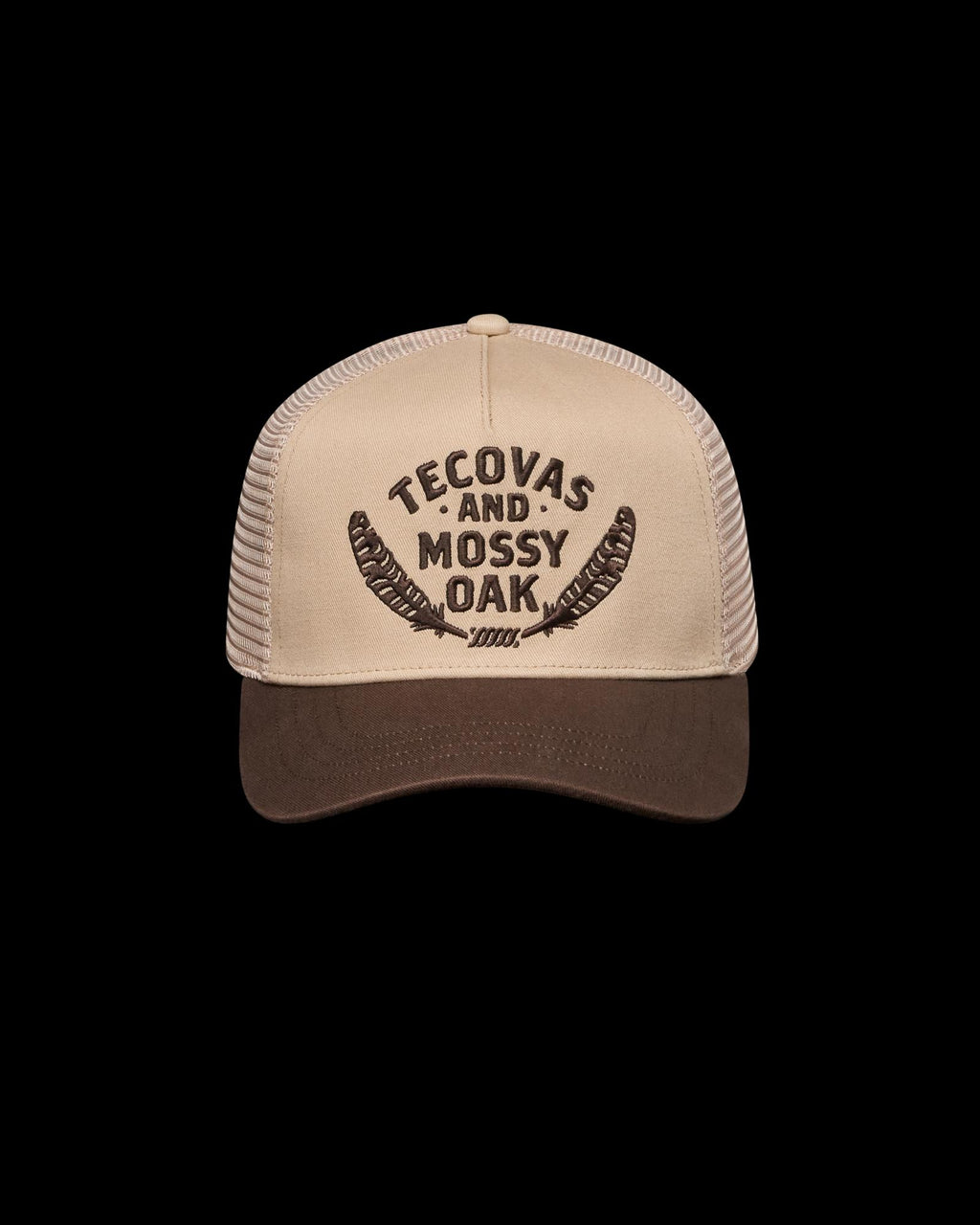 A tan and brown trucker hat with "Tecovas and Mossy Oak" and feather graphics embroidered on the front.