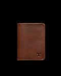 Brown leather wallet with a minimalist design, featuring a small embossed logo on the bottom right corner, set against a black background.