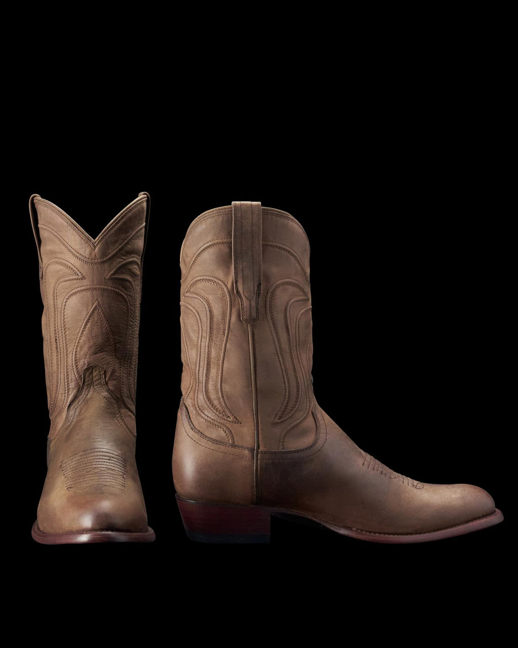 A pair of brown cowboy boots, one facing front and the other showing the side profile, displayed on a plain background.