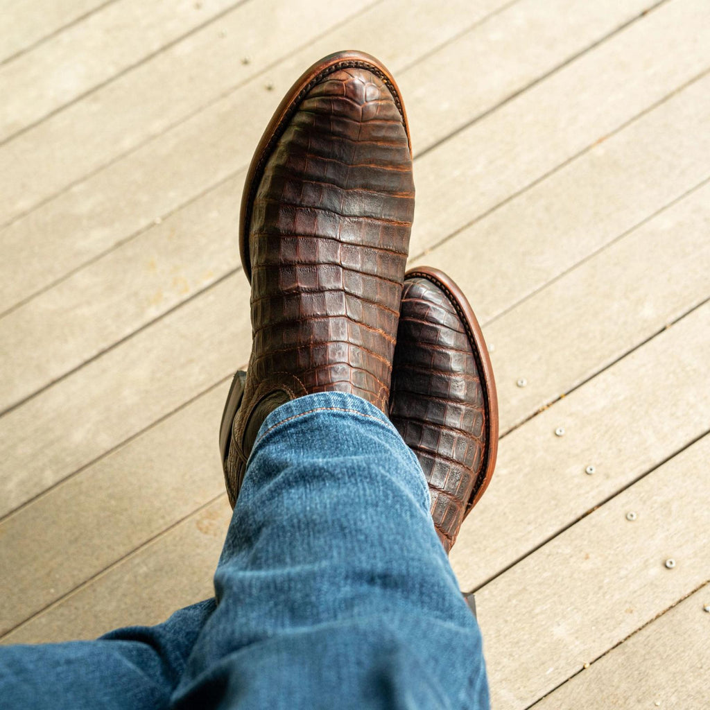 close up picture of Earl Mahogany brown cowboy boots on a man's feet