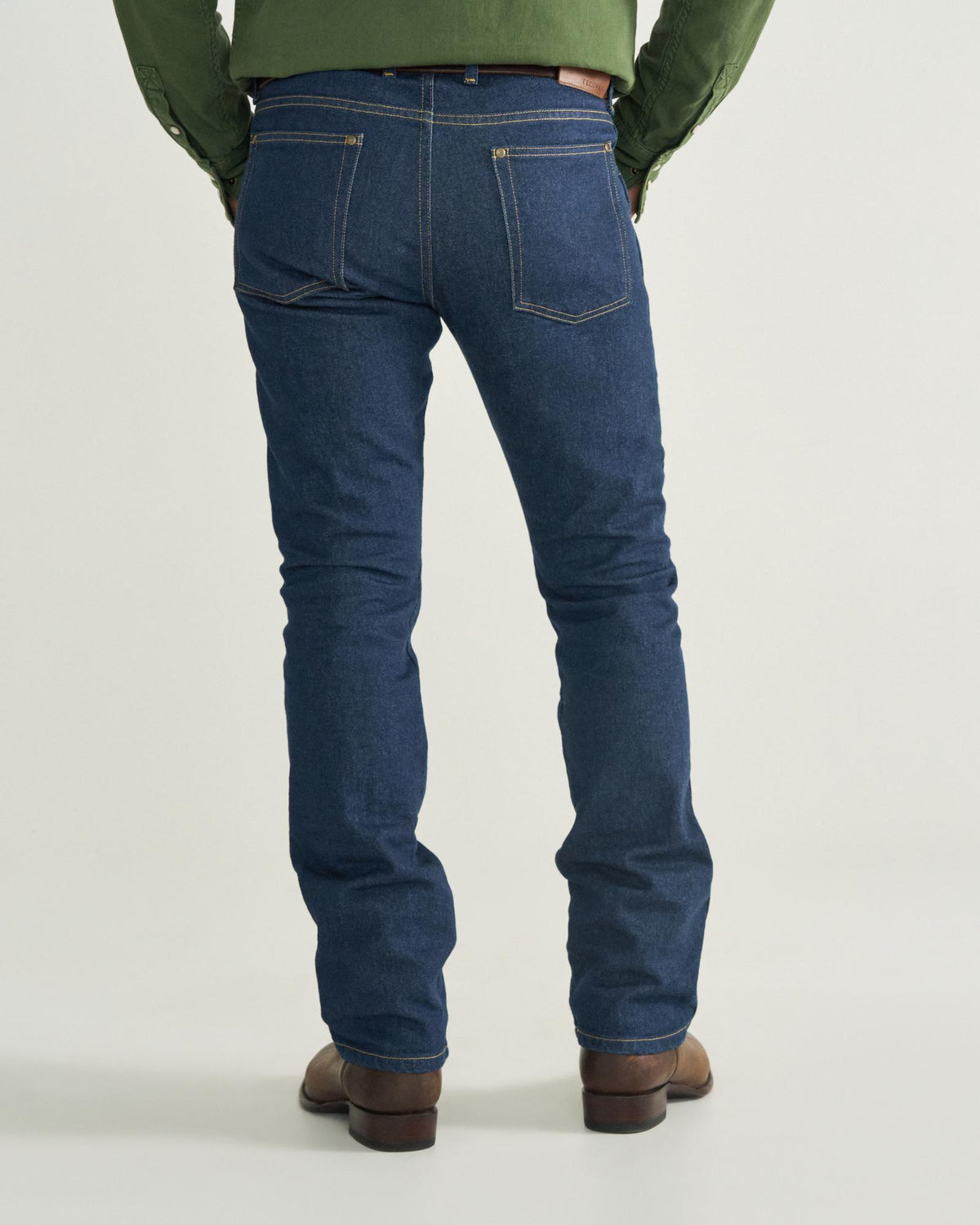 Back view of Men's Slim Straight Heritage Denim - Dark Blue on model