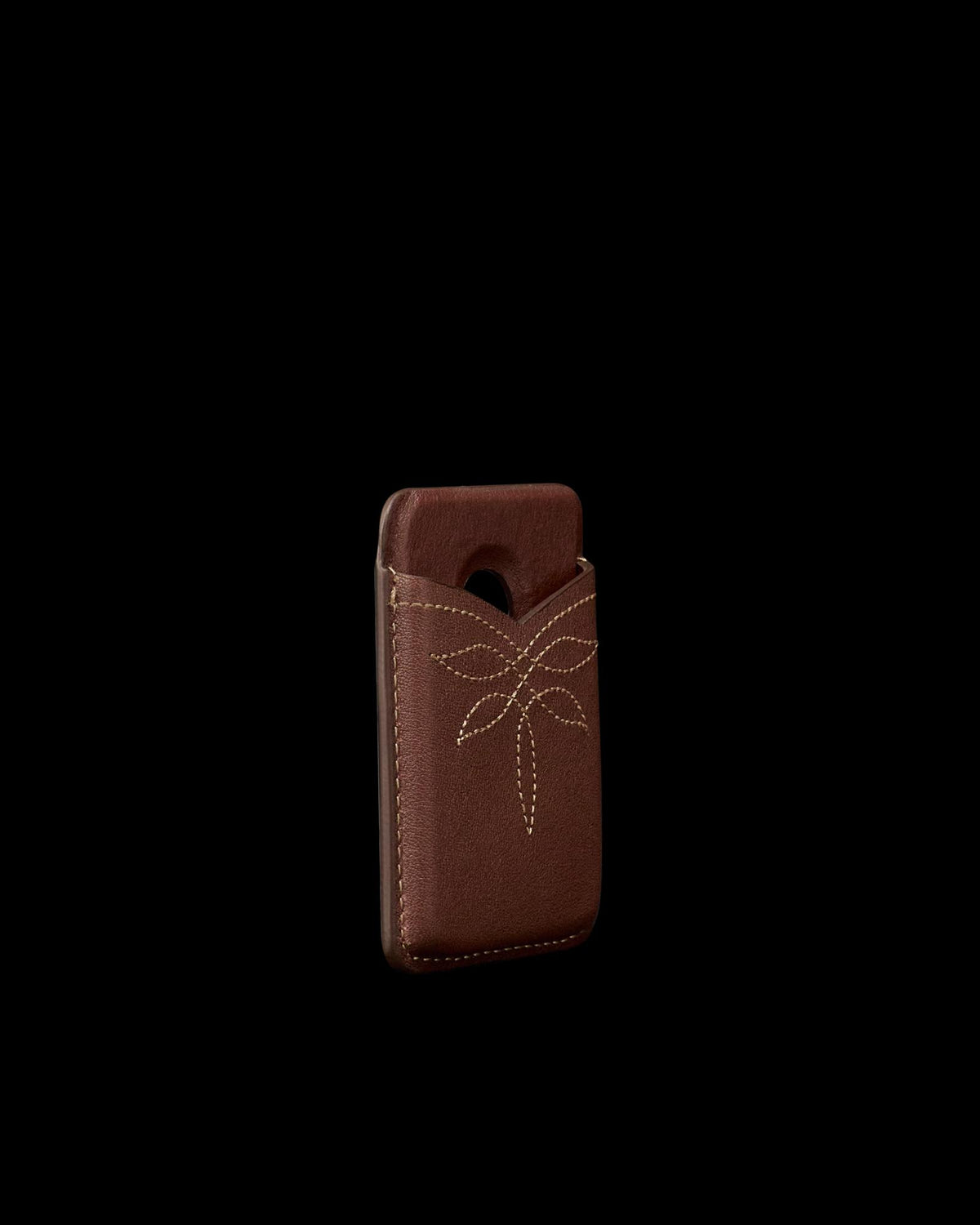 Quarterfront view of Cowhide MagSafe Card Holder - Brown on plain background