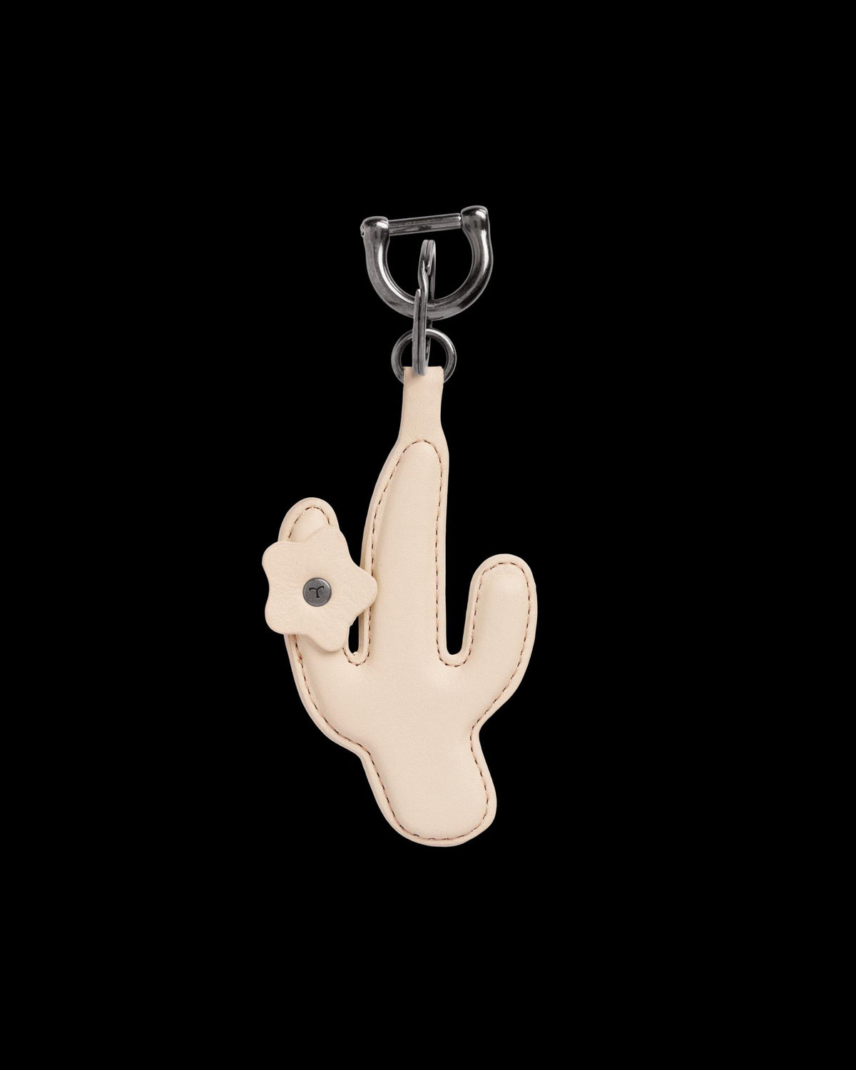 A beige cactus-shaped leather keychain with a small flower detail attached near the top left side.