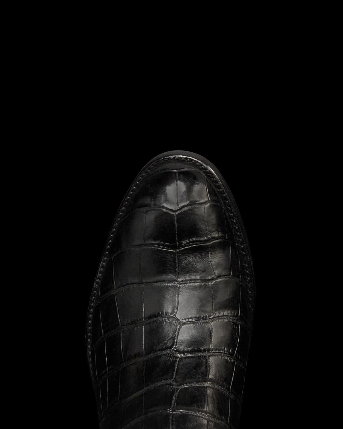 Toe view of The Stallion x Tecovas Boot - Midnight Giant Gator on plain background