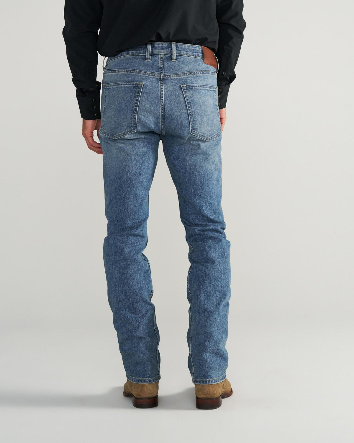 Back view of Men's Slim Straight Stretch Denim - Medium Light on model