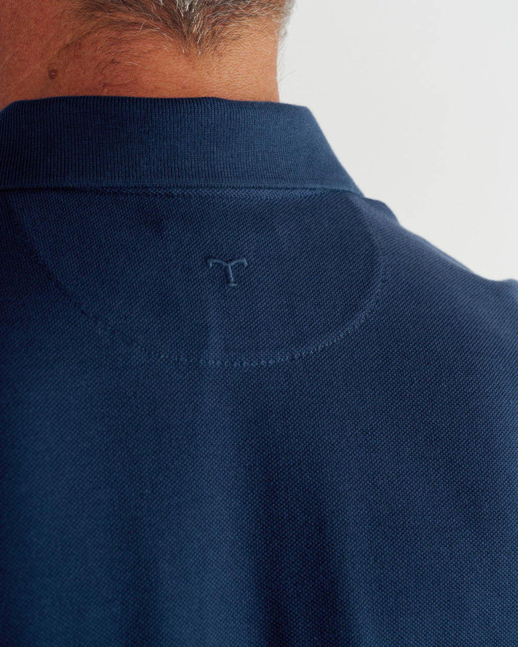 Closeup detail view of Men's Polo Pearl Snap SS - Navy