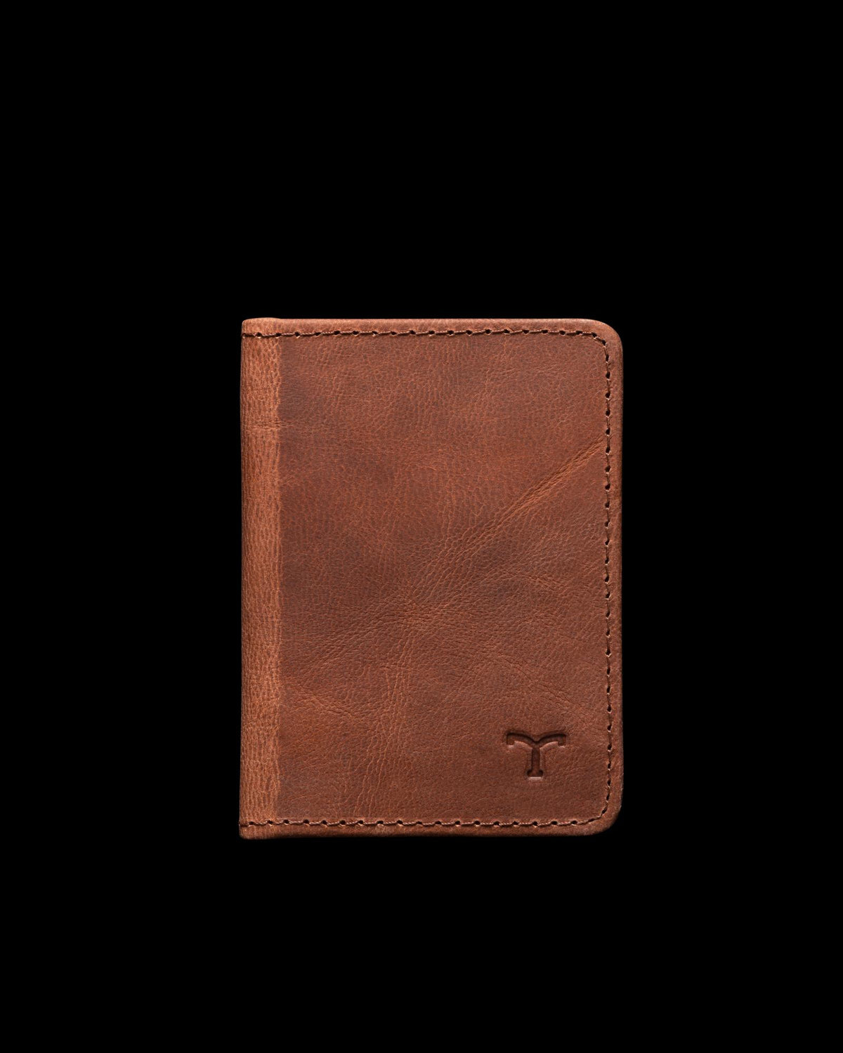 A brown leather wallet is standing upright against a plain white background. The wallet has visible stitching and a small embossed logo in the bottom right corner.