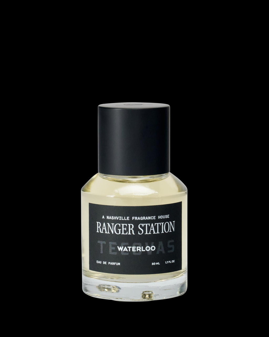 A clear glass bottle of Ranger Station Waterloo eau de parfum with a black cap and a black label featuring white text.