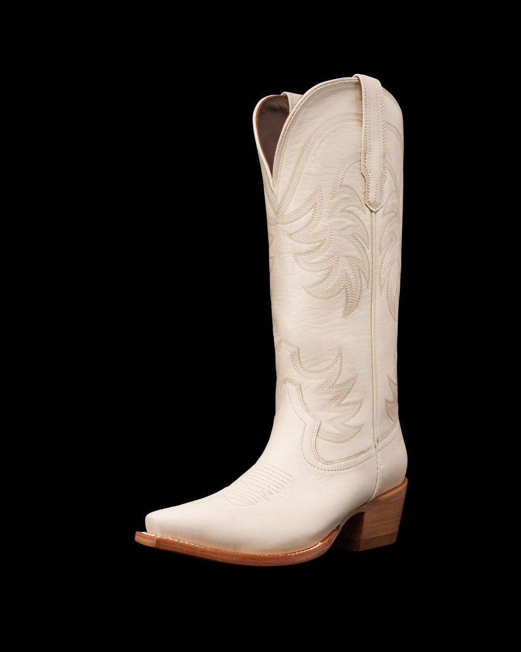 A single white cowboy boot with decorative stitching and a wooden heel is shown against a plain background.