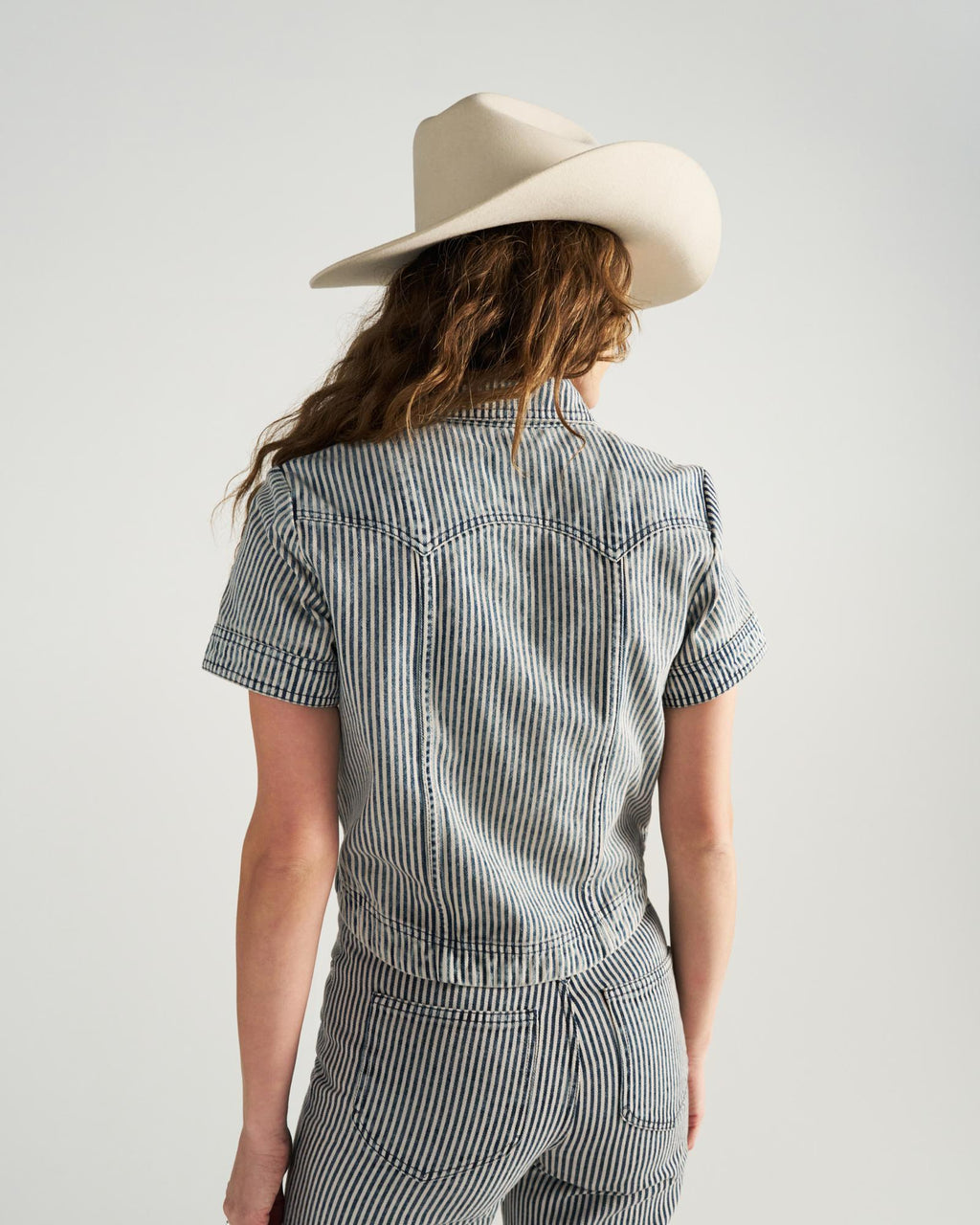 Back view of Women's S/S Denim Top - Blue / White on model