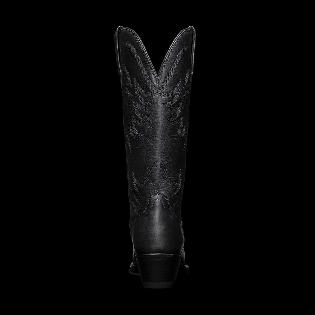 Black cowboy boot with intricate stitching, viewed from the back against a plain white background.