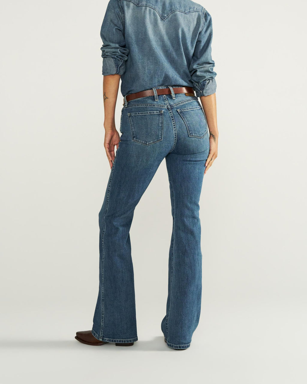 Back view of Women's Mid-Rise Slim Flare - Medium Wash on model