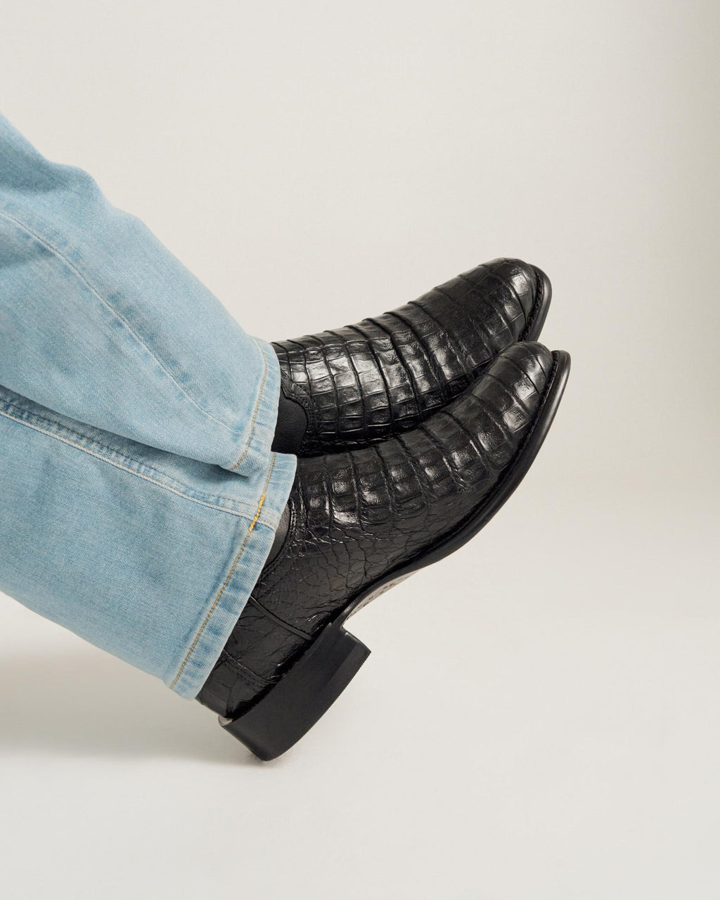 close up picture of Earl Carbon Black cowboy boots on a man's feet
