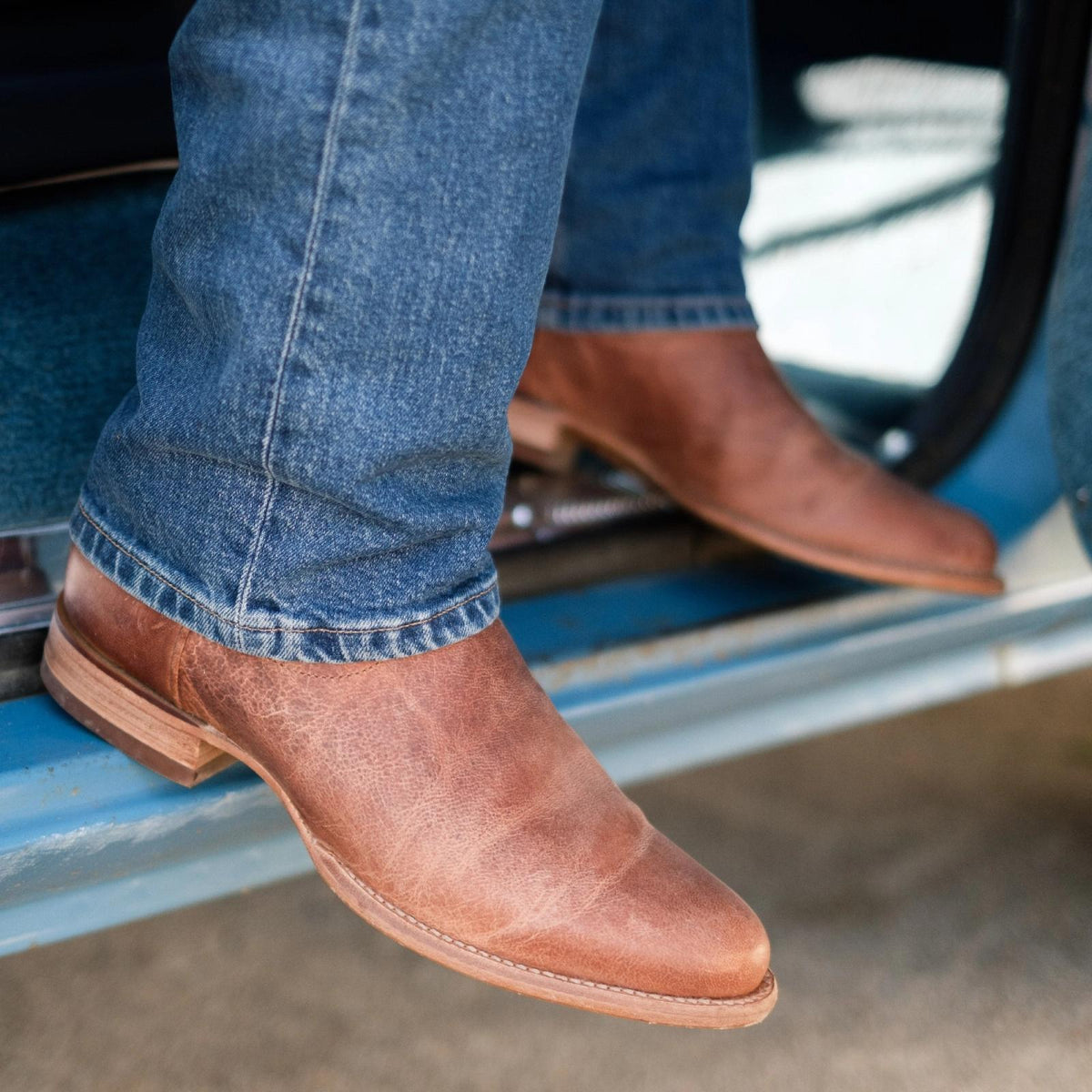 close up picture of Earl scotch brown cowboy boots on a man's feet
