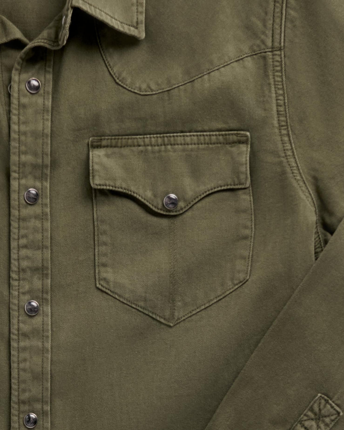 Close-up of a Tecovas olive green western shirt showing a chest pocket with snap closure and snap-button placket.