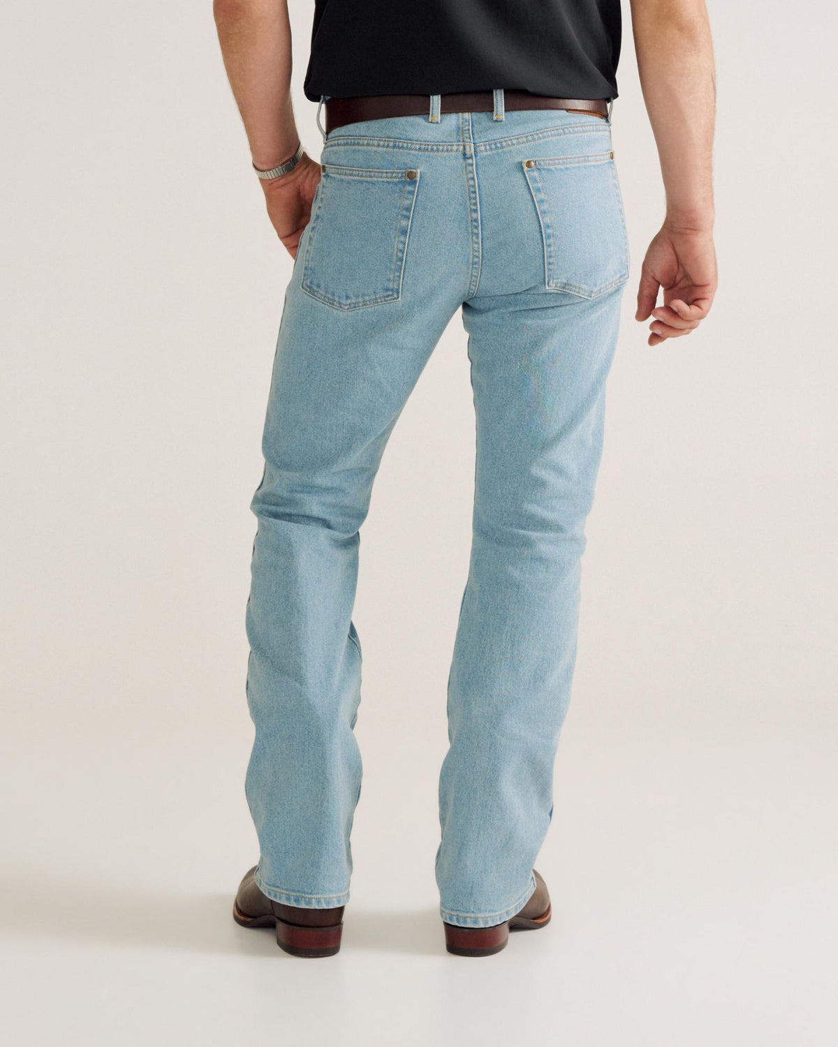 Back view of Men's Modern Bootcut Heritage Denim - Light Blue on model