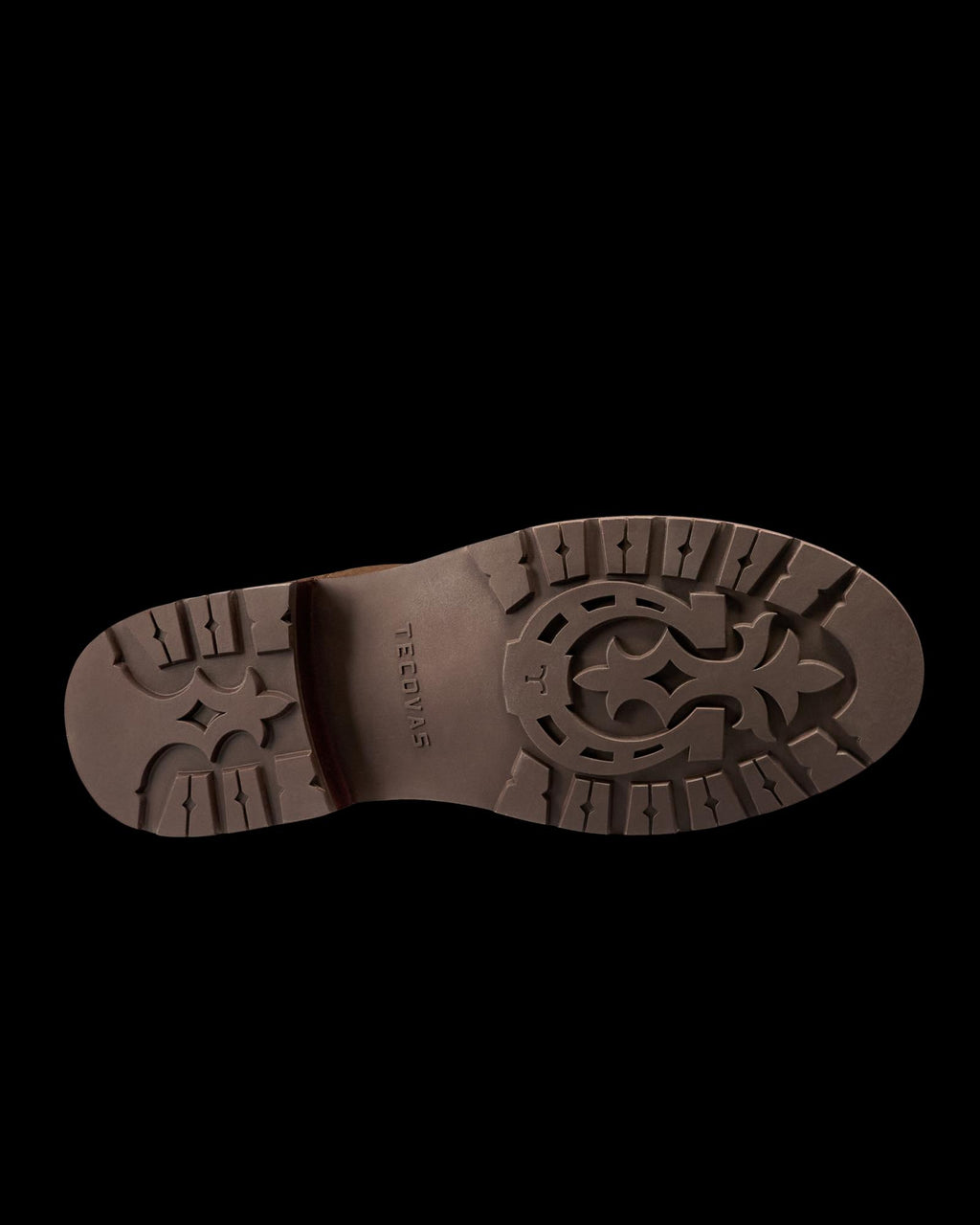 Brown shoe sole viewed from below, featuring a patterned tread design and the word “TAFT” embossed in the center—an essential detail in the refined craftsmanship of The Chelsea Cowhide collection in Cafe Cowhide.