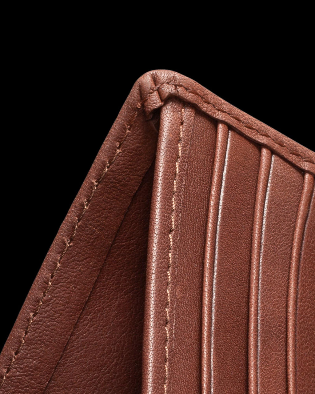 Close-up of a brown leather wallet with visible stitching and multiple card slots.
