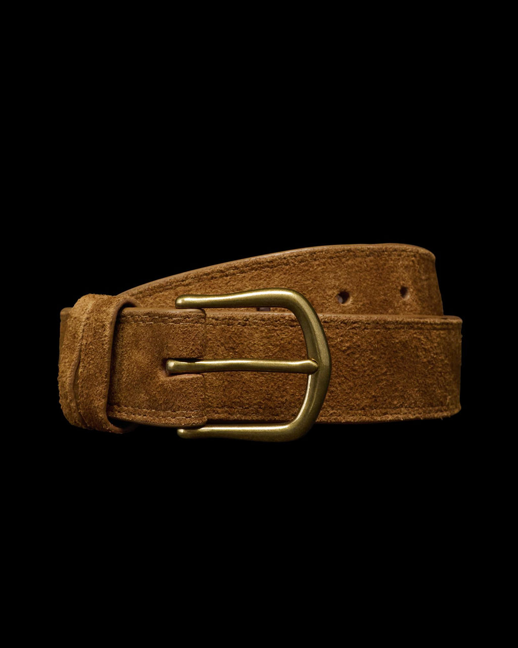 A brown suede belt with a brass buckle is coiled against a plain white background.