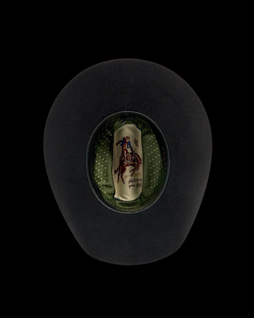 Black cowboy hat shown from above, revealing a green polka dot inner lining and a label with a rider on a horse.
