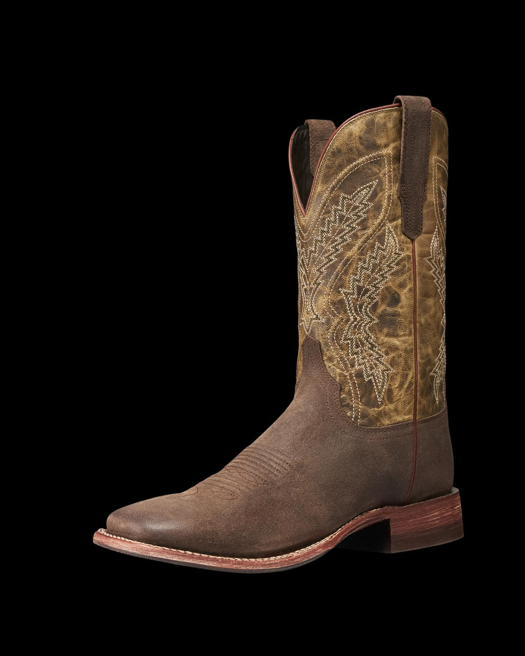 The Doc in Moss Suede. Brown leather cowboy boot with decorative stitching, a round toe, pull straps, and a low wooden heel, featuring elegant moss suede accents, shown on a white background.