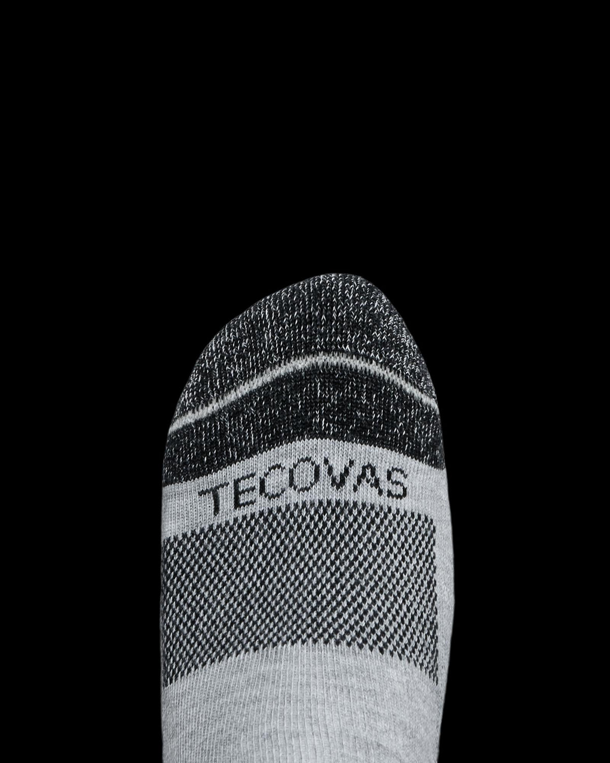 Gray and black sock with the word "Tecovas" on the toe, shown against a plain white background.