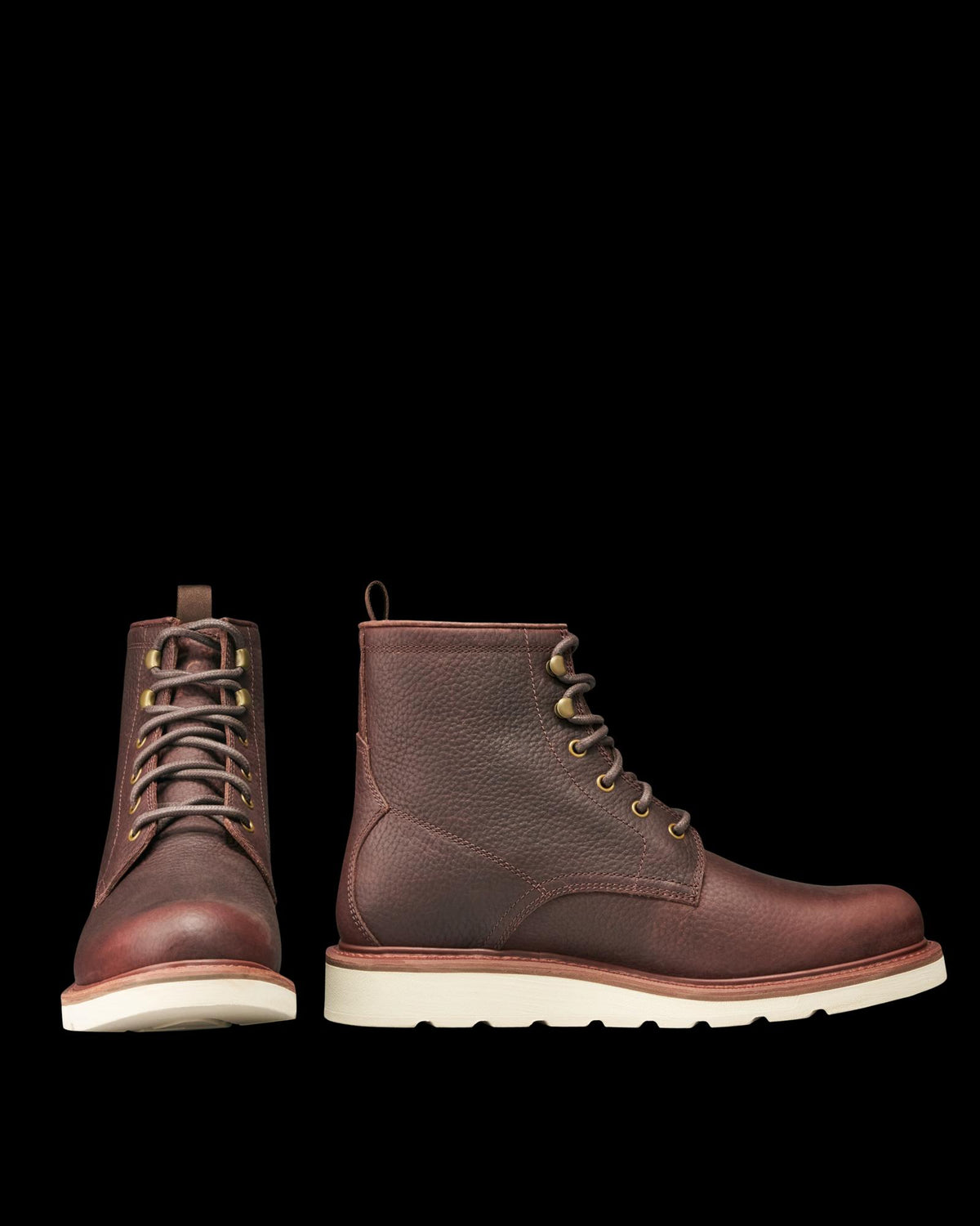 The Knox Lace Up in Cognac Cowhide. Front and side view of cognac cowhide lace-up boots with white rubber soles.