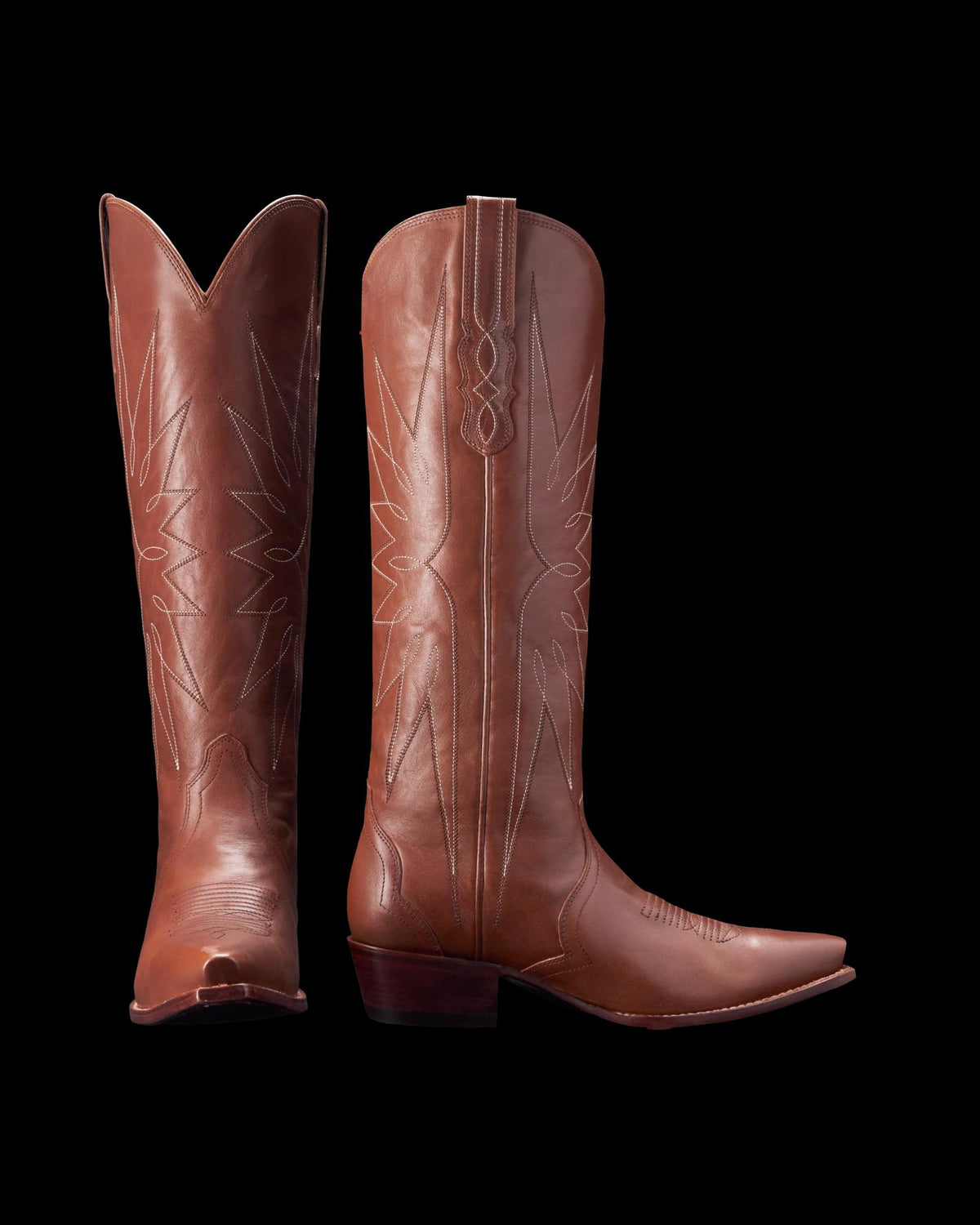 Pair of brown cowboy boots with decorative stitching, standing upright.