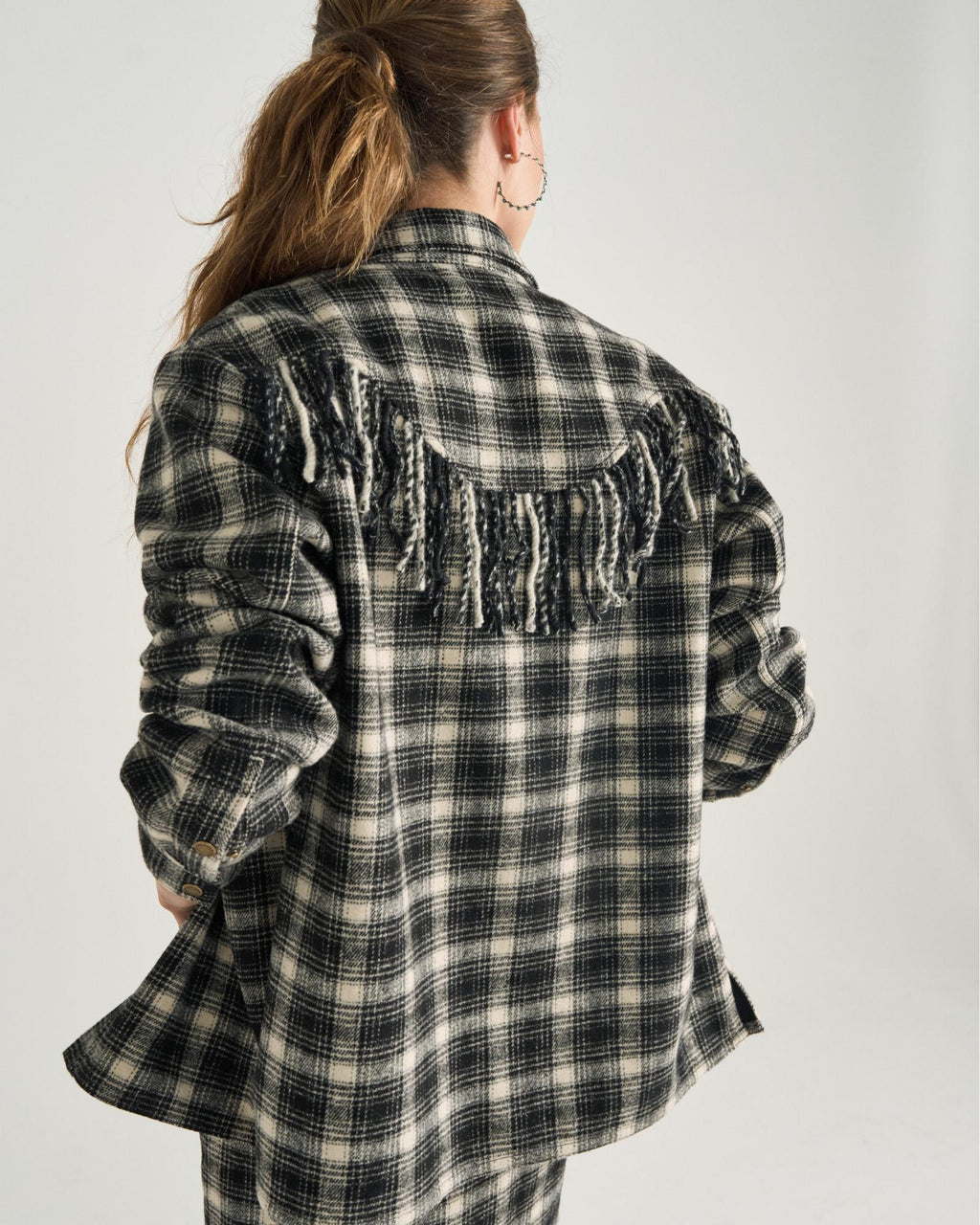 Closeup detail view of Women's Plaid Fringe Shacket - Black / White