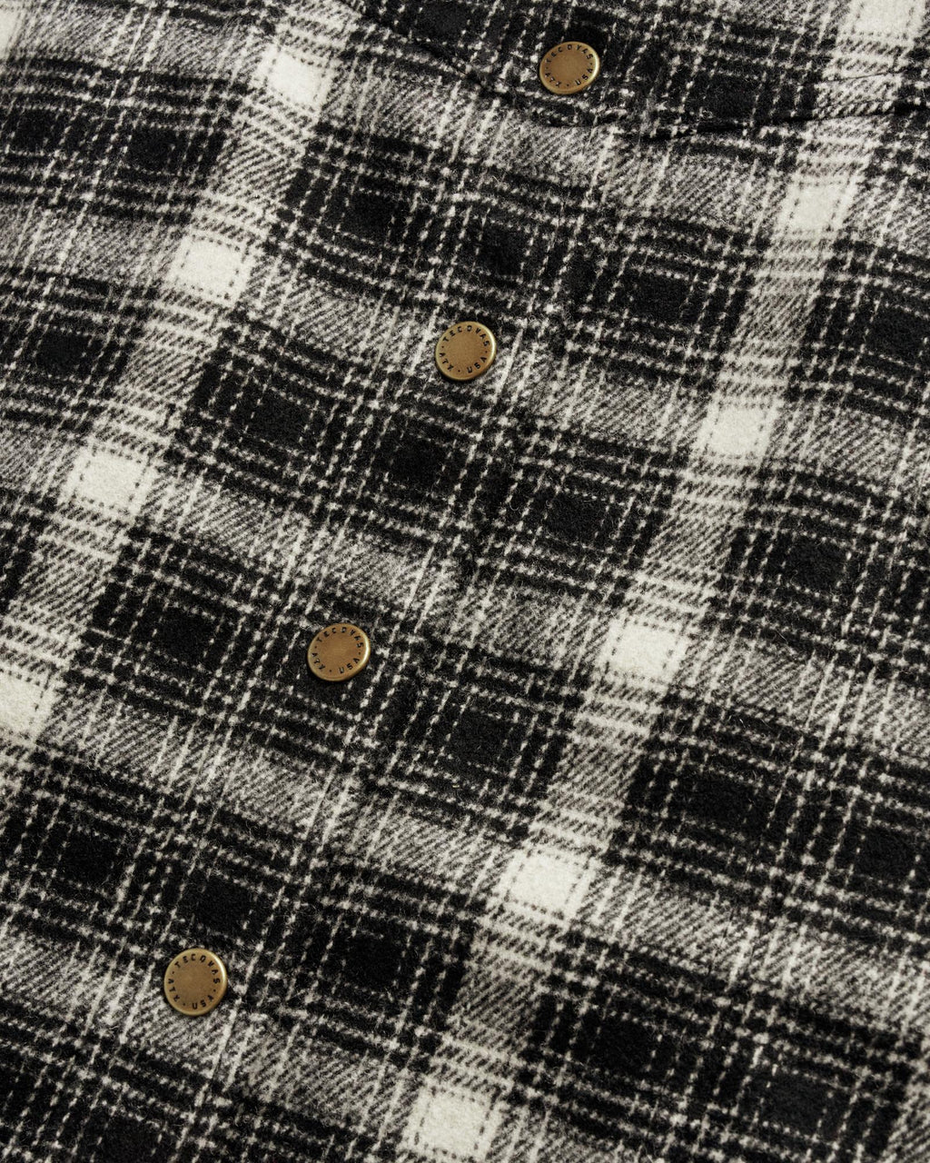 Closeup detail view of Women's Plaid Mini Skirt - Black / White