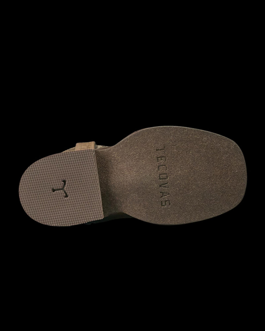 The photo shows the bottom sole of a brown boot with “TECOVAS” embossed near the heel and a textured area near the toe.
