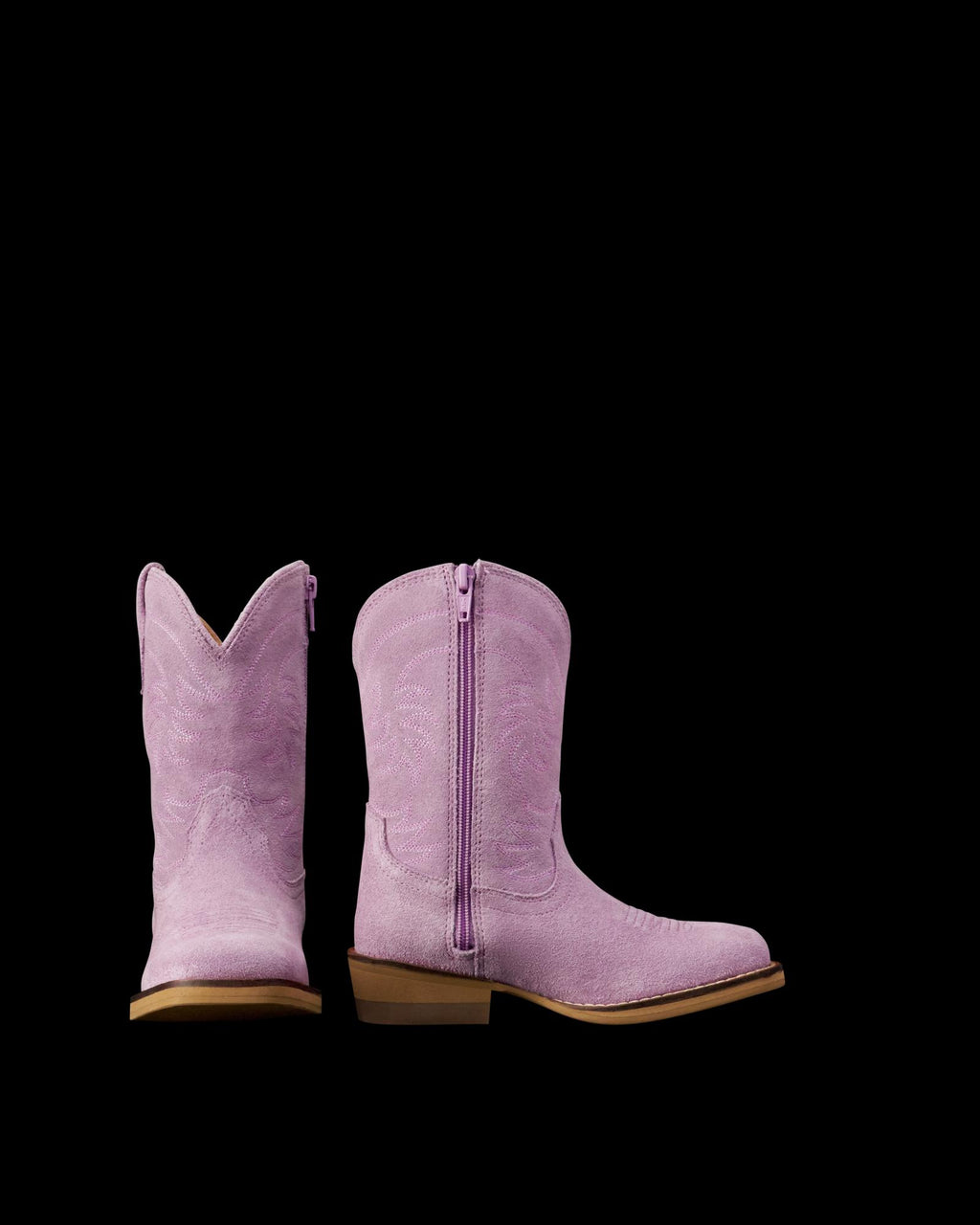 A pair of children's pink cowboy boots, one facing forward and the other showing a side view with a zipper, on a plain white background.