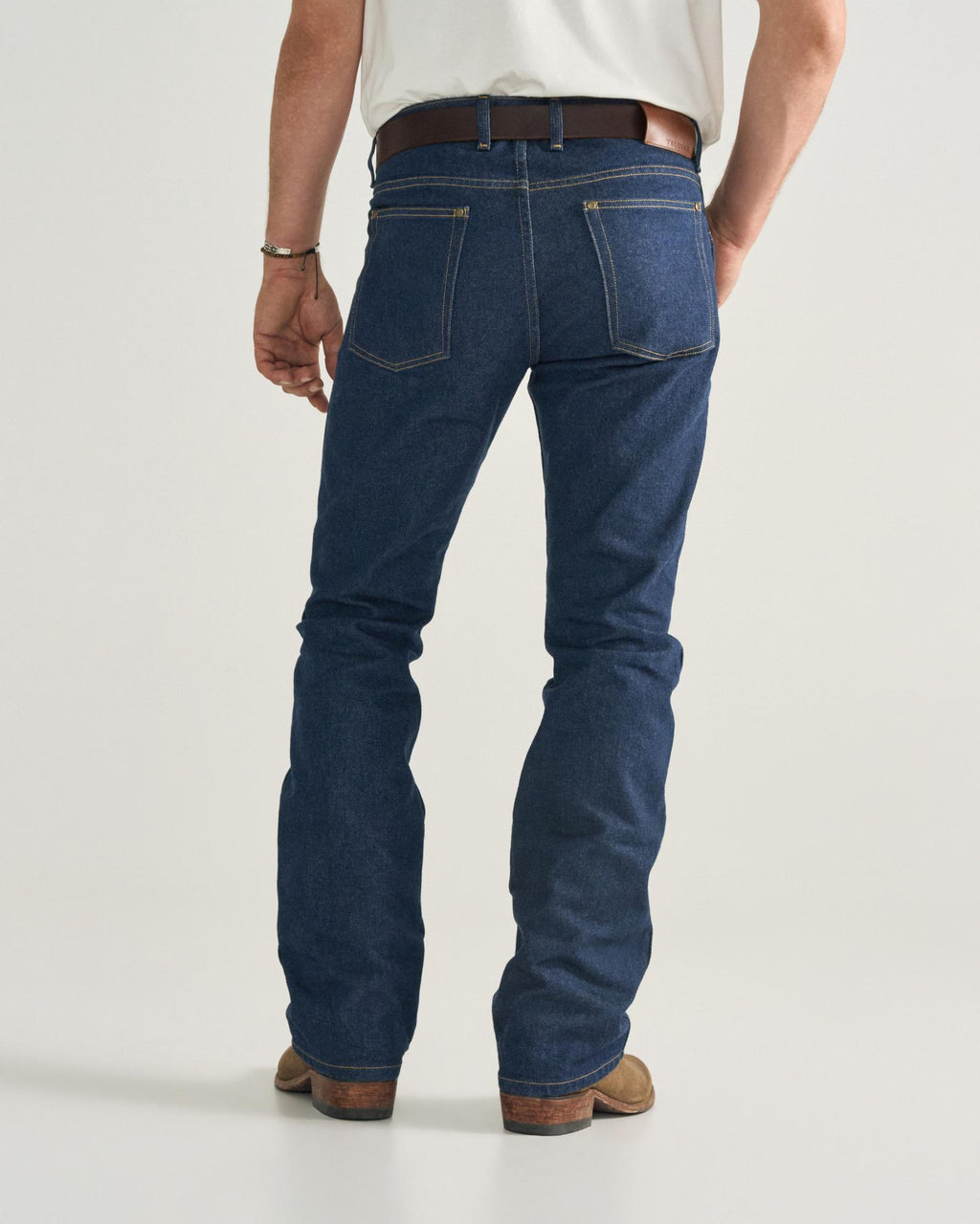 Back view of Men's Modern Bootcut Heritage Denim - Dark Blue on model