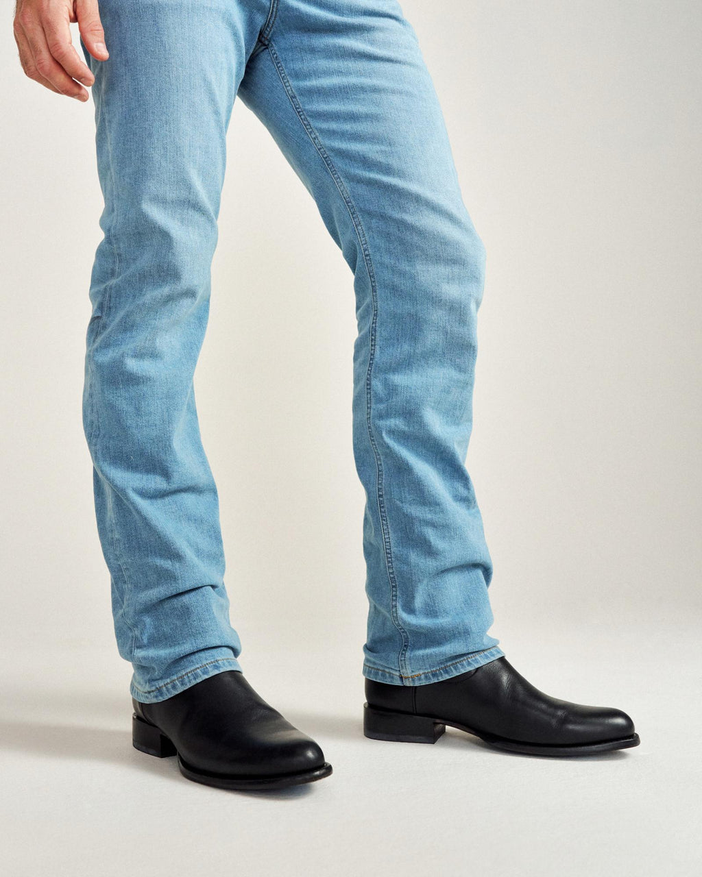 close up picture of Earl midnight black cowboy boots on a man's feet