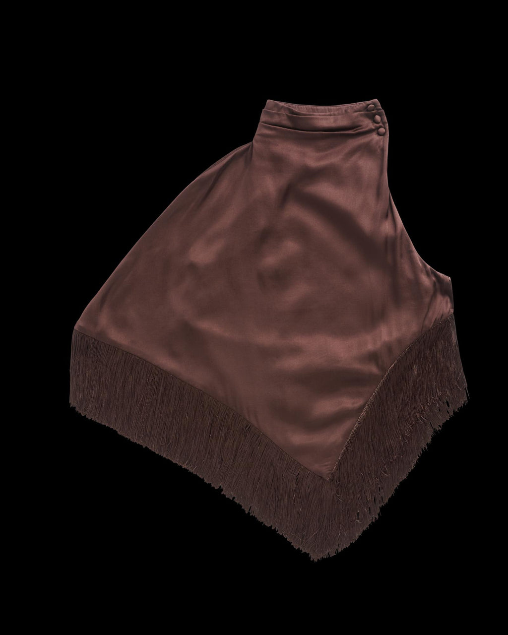 Brown satin asymmetrical wrap skirt with fringe trim along the bottom edge, featuring button closure at the waist, displayed on a white background.