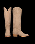 A pair of tall, tan cowboy boots with intricate stitching and wooden heels, displayed against a black background.
