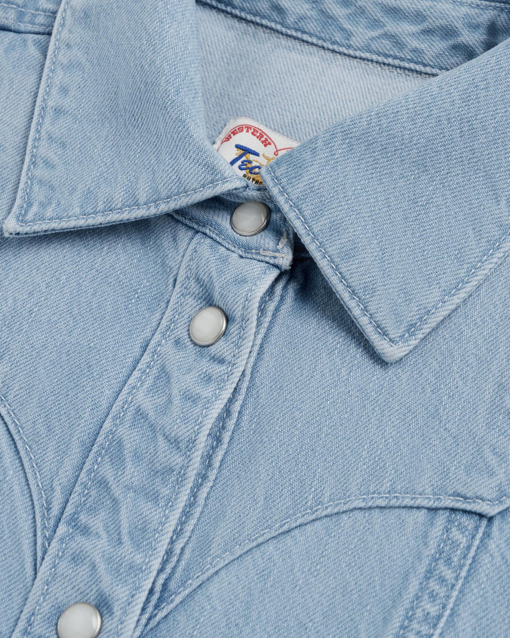 Closeup detail view of Women's Short Sleeve Mini Pearl Snap Dress - Light Wash